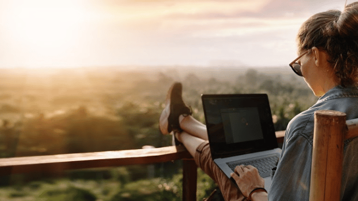 woman-sitting-on-deck-with-laptop