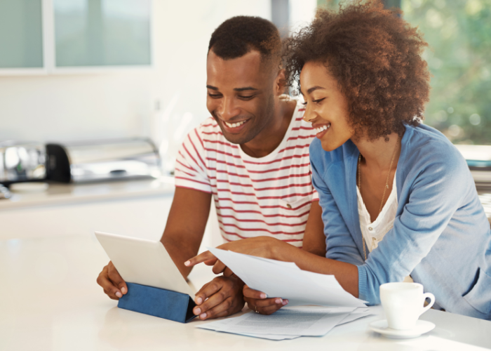 Alt tag: young diverse couple reviewing money market accounts