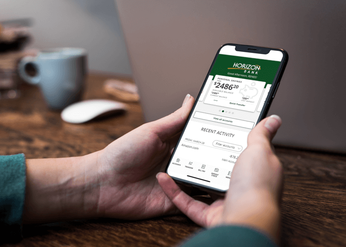 Person using the Horizon Bank mobile app to securely access account information on a smartphone