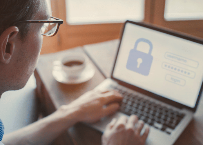 Person signing onto an account through a secure login screen with account credential verification on their laptop