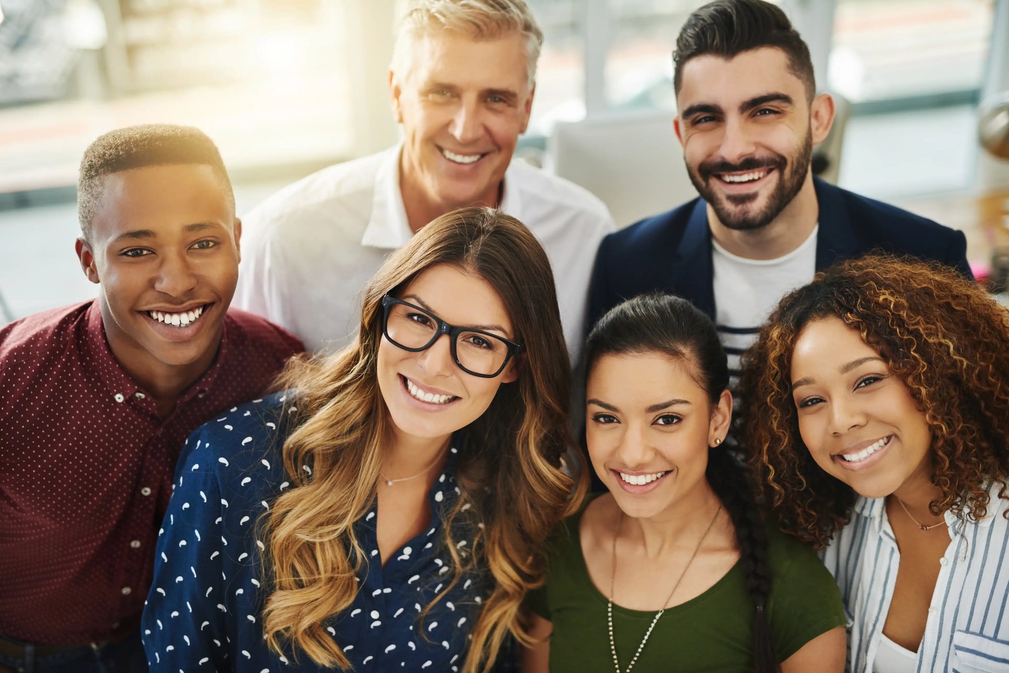 Diverse group of adults gathered together, smiling