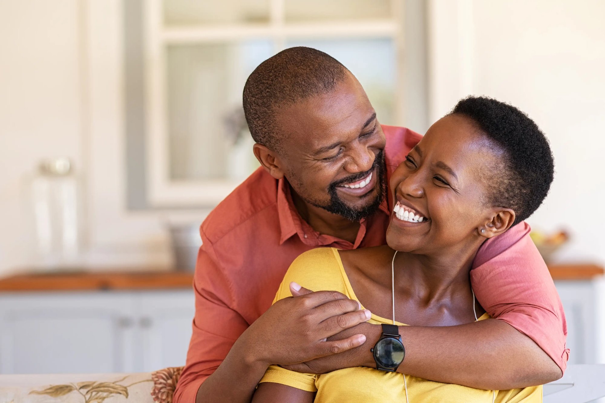 Smiling couple embracing each other while enjoying a moment together