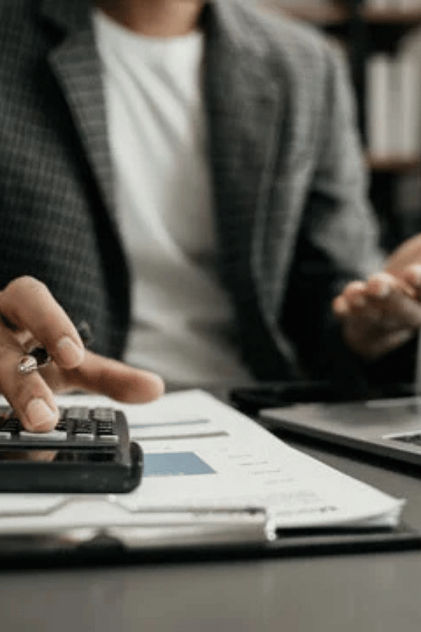business-analyst-using-calculator-vertical