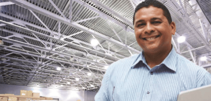 man-smiling-in-manufacturing-warehouse
