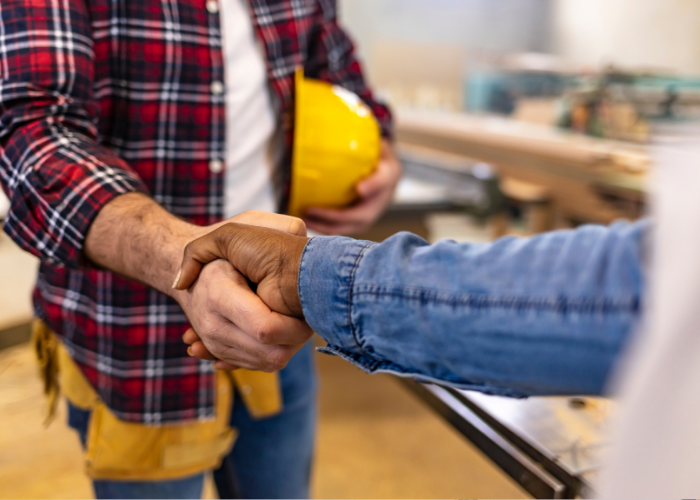 Construction workers shaking hands.