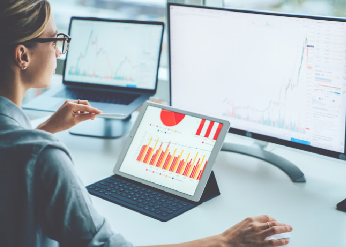 woman-working-on-computer-with-financial-graphs